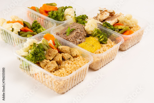 Healthy vegetables and meat packed lunch box meal in front top aerial view clean white background