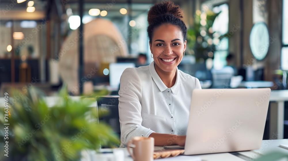 Professional woman with a pleasant smile sitting at her office desk Professional woman with a pleasant smile sitting at her office desk