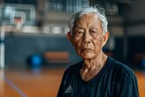 Portrait of a senior asian man in indoor basketball gym