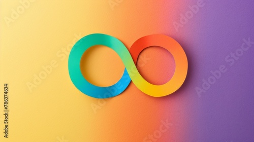 A minimalist, colorful paper cutout of an infinity symbol is set against a rainbow-colored background.