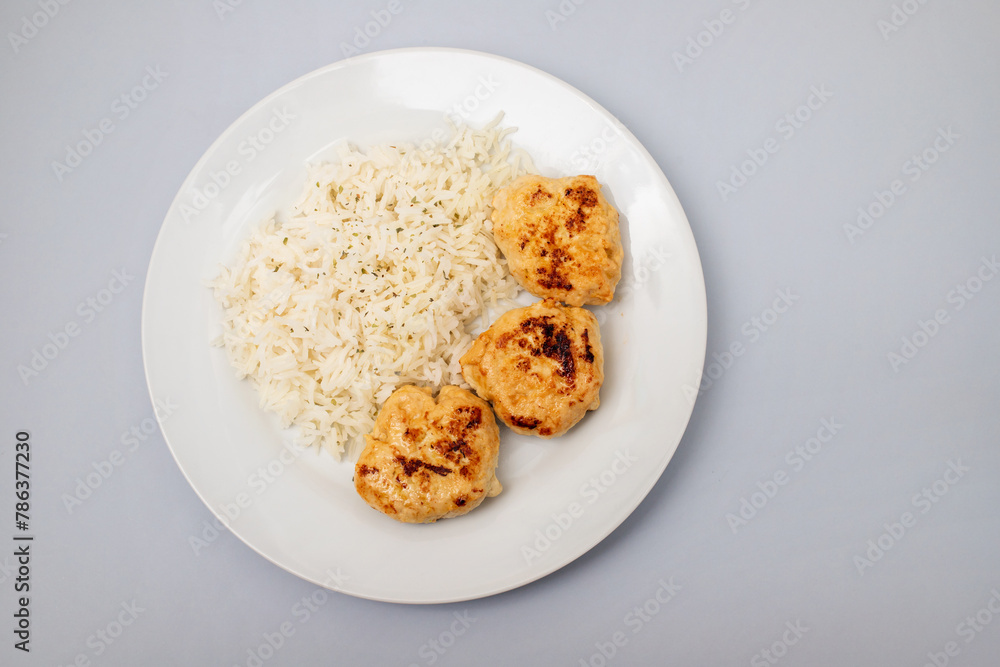 Fried chicken meatballs with boiled rice on plate Fried chicken meatballs with boiled rice on plate