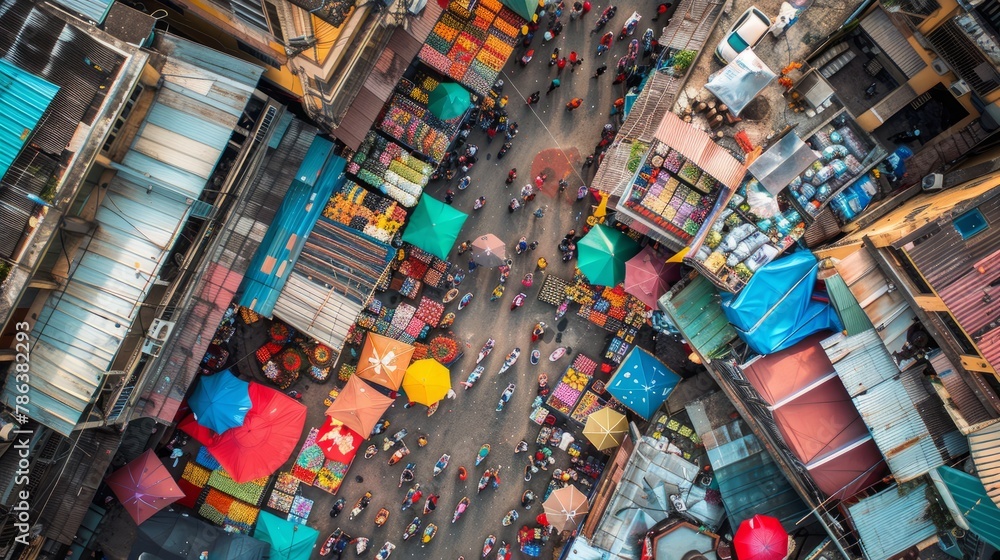 Overhead view of busy street market with vibrant umbrellas shading stalls and vendors selling various goods