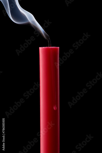 Pink wax candle with smoke on black background