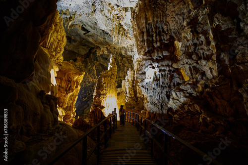 Rear View of woman standing inside big cave