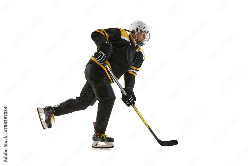 Young man wearing black and yellow uniform, hockey player in motion with stick during game isolated on white background. Concept of professional sport, competition, game, tournament Young man wearing black and yellow uniform, hockey player in motion with stick during game isolated on white background. Concept of professional sport, competition, game, tournament