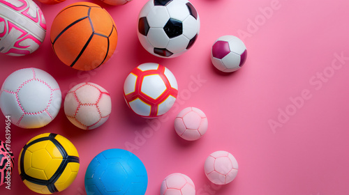 Many different sports balls on pink background