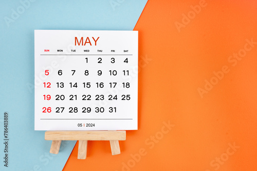 2024 May calendar page on blue and orange background.