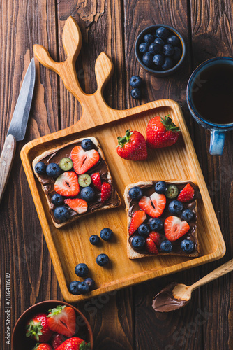 Sandwich with chocolate paste and strawberries and blueberries