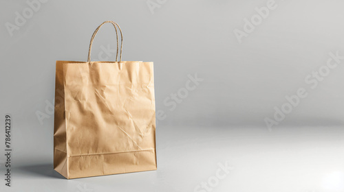 One paper bag on grey background space for text. Mocku