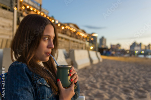 Young woman drinking traditional mate (chimarrao) from Uruguay. Gaucha Culture.