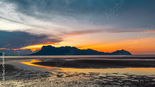 Sunset on the beach in Bako National Park  Borneo  Malaysia  Fiery colors of the sky  low tide of the sea and view of Mount Santubong