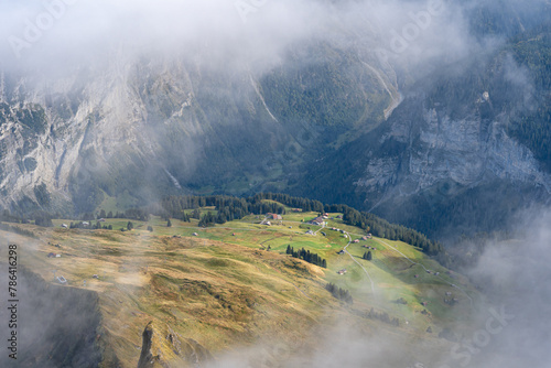 View of Lauterbrunnen valley in Swiss Alps. Bright sunny day with low clouds in Switzerland