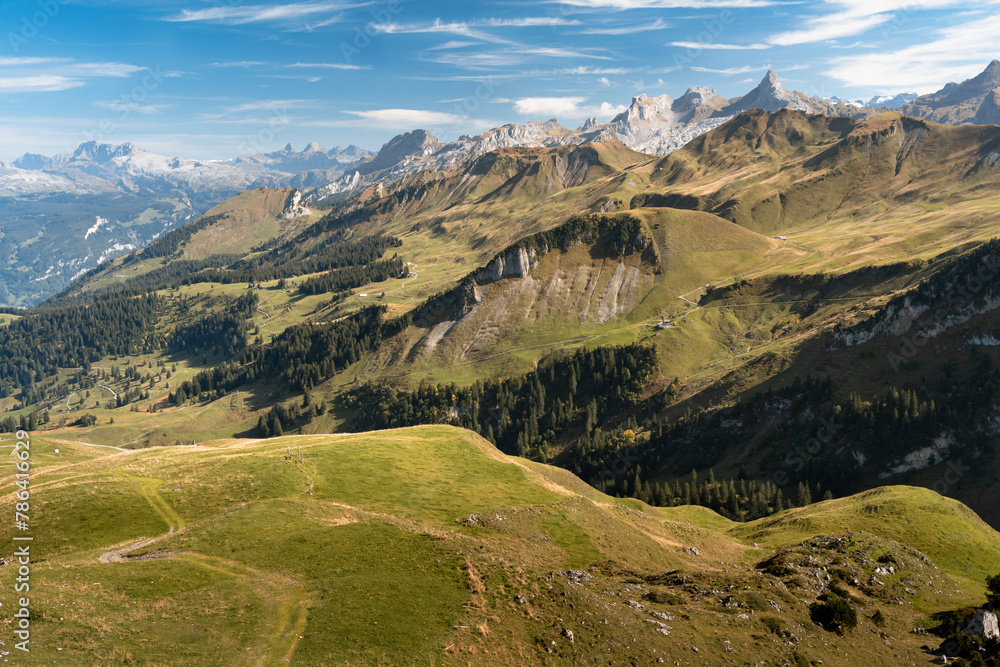 Aerial view of Swiss Alps near Fronalpstock in Stoos, Switzerland. Walking trails in mountains. Bright, sunny day.