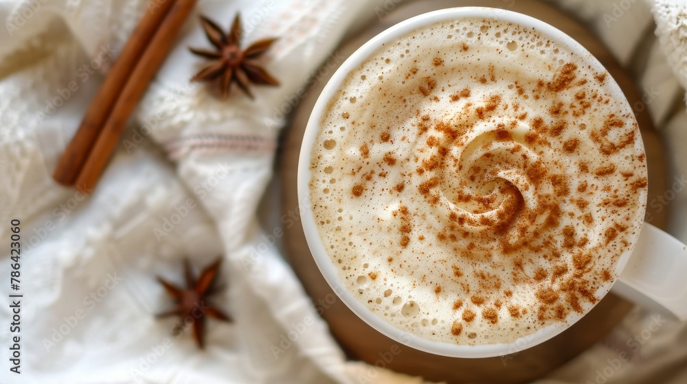 Close up of delicate cinnamon swirls atop cappuccino foam in a stylish white coffee cup Close up of delicate cinnamon swirls atop cappuccino foam in a stylish white coffee cup