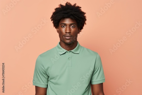 Portrait of a blissful afro-american man in his 20s wearing a breathable golf polo isolated in modern minimalist interior