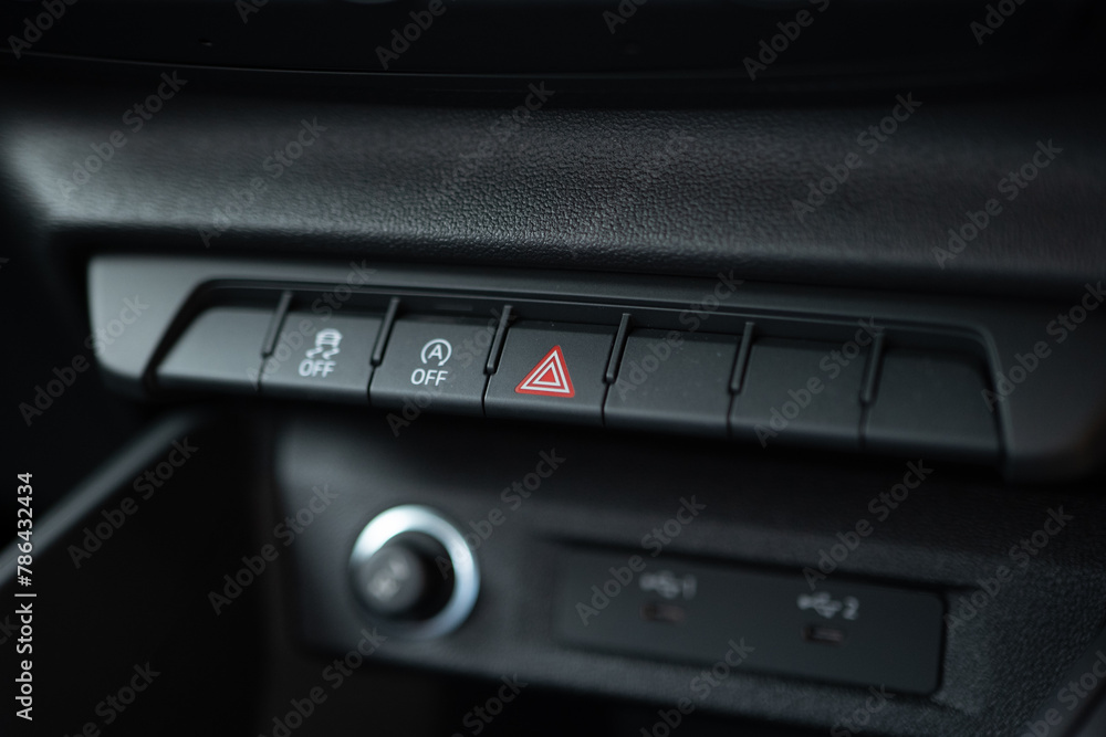 Red hazard warning lights button closeup. Car interior. Red hazard warning lights button closeup. Car interior.