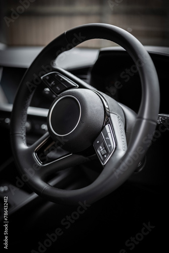 black car steering wheel close-up. Modern design. Car interior. Travel.  © Ian