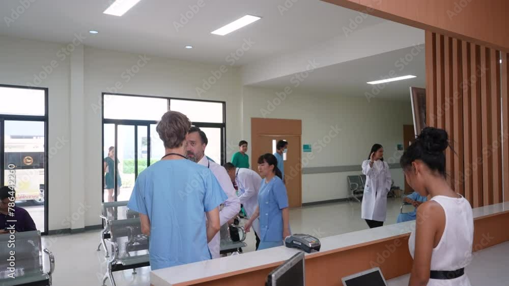 Group of physicians and patients people in waiting area in busy hospital, many patients waiting in queue to visit doctors at reception desk, medical trainee man consult senior surgeon in sickness case Group of physicians and patients people in waiting area in busy hospital, many patients waiting in queue to visit doctors at reception desk, medical trainee man consult senior surgeon in sickness case