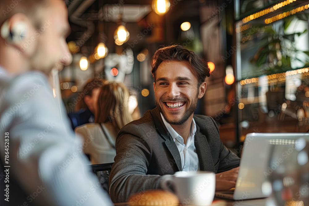 Happy businessman in meeting with colleague at cafe Happy businessman in meeting with colleague at cafe