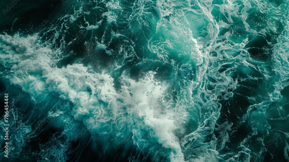 Turquoise sea wave as it swirls and breaks in the water foam up close