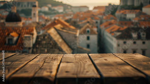 Atmospheric shot of a simple wooden table set against a dreamy blur of Dubrovnik's old town  merging past with present