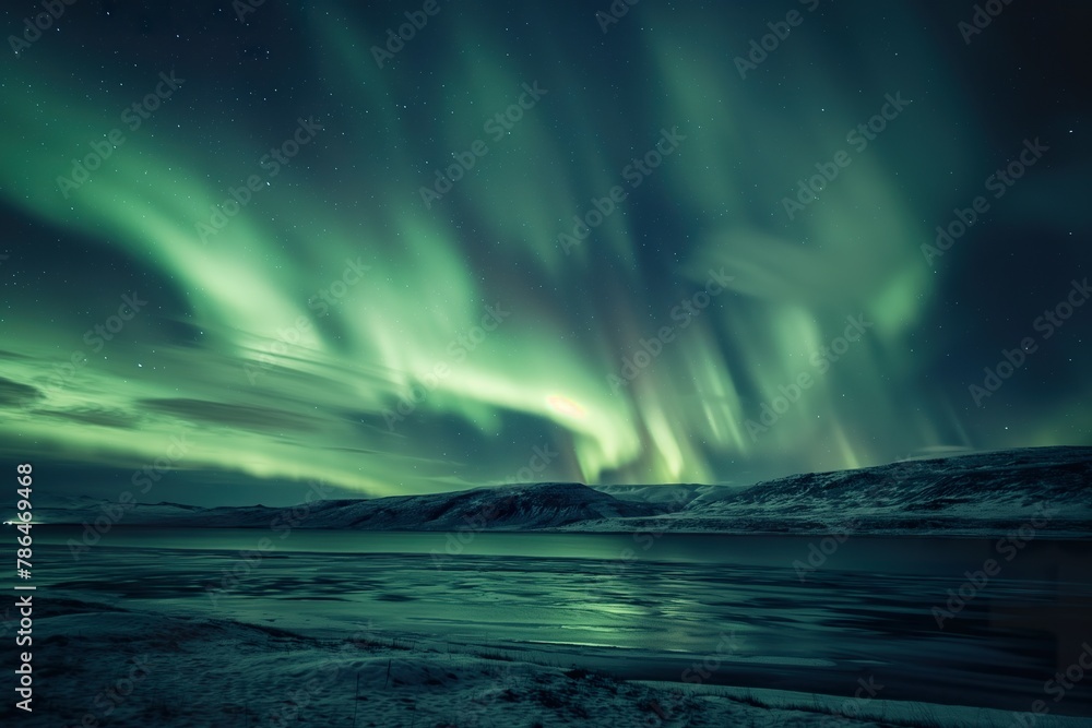 A green and purple aurora borealis lights up the sky over a tranquil body of water. A green and purple aurora borealis lights up the sky over a tranquil body of water.