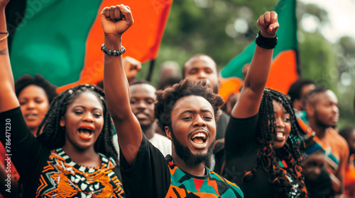 African Americans celebrating Juneteenth, fists raised high, with a backdrop of the Pan-African flag photo