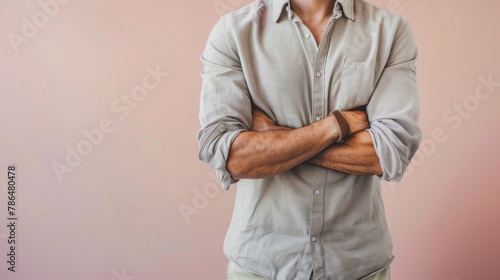 A casual chic portrait of a man in a button-down shirt and chinos, representing everyday style. 