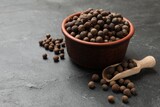 Dry allspice berries (Jamaica pepper) on black table, space for text