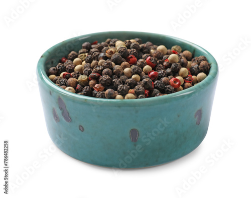 Aromatic spices. Different peppers in bowl isolated on white