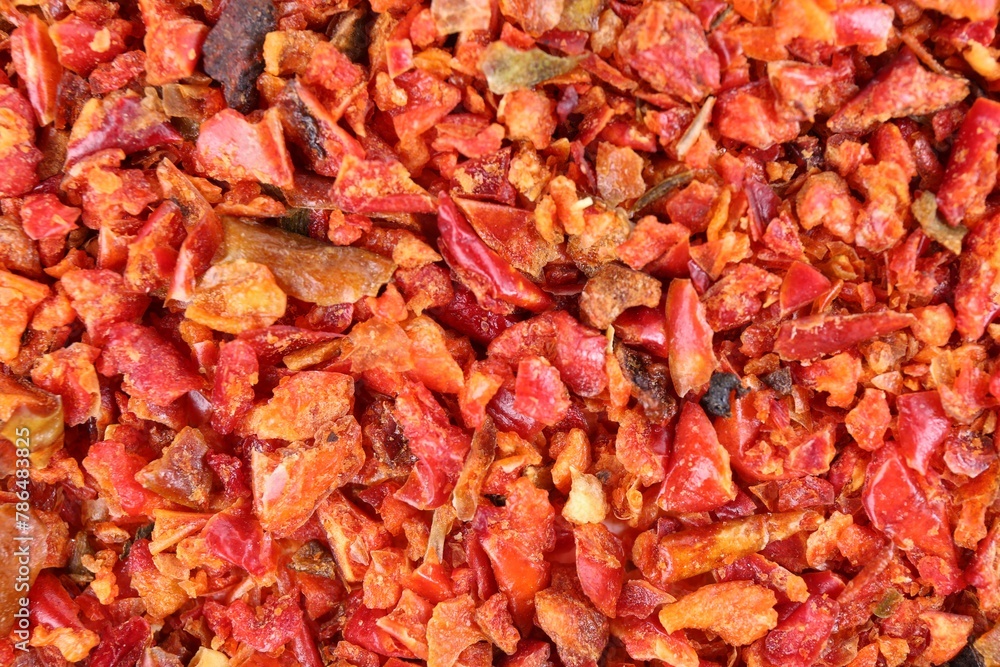 Aromatic spice. Red chili pepper flakes as background, top view Aromatic spice. Red chili pepper flakes as background, top view