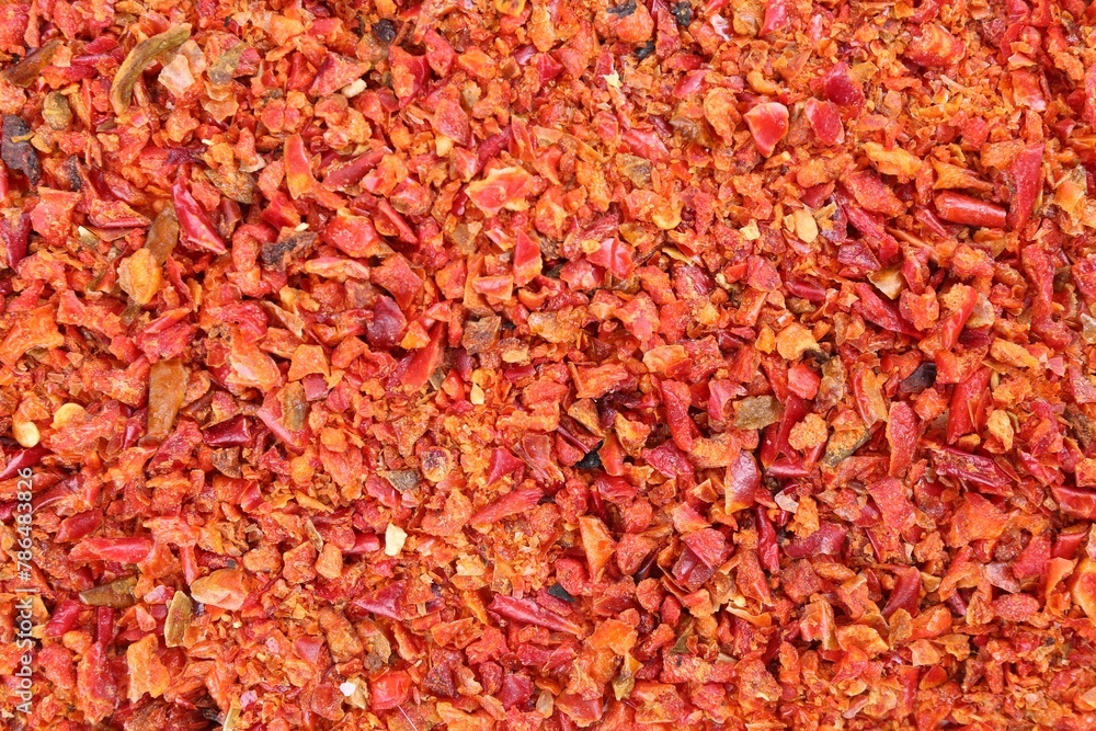 Aromatic spice. Red chili pepper flakes as background, top view
