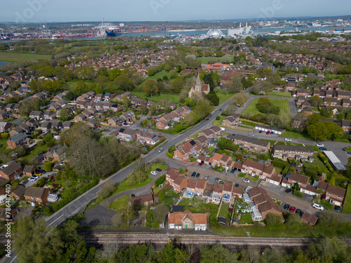 Panoramic view of Marchwood village with railway tracks and church. Aerial view towards industrial Southampton Docks and Marchwood Power station.