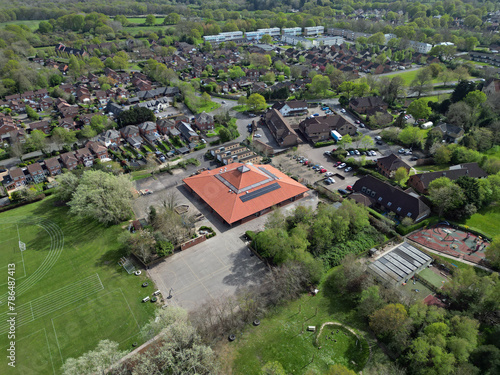 Marchwood town center with school playgrounds and green recreational area. Aerial view of the village.