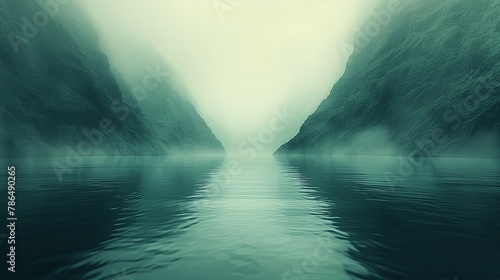   A body of water surrounded by mountains in a foggy region of land