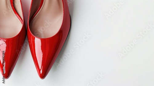 Red high heeled shoes against a white backdrop