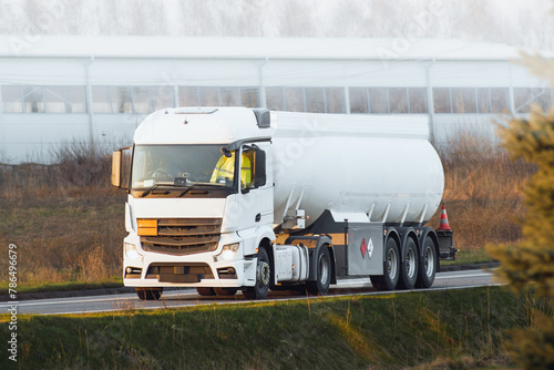 Automotive fuel tankers shipping fuel. Isothermal Tank truck driving on a highway.