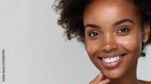 High-resolution cropped photograph showcasing skincare and cosmetics concept, featuring ample space for text. A woman with a stunning visage gently caresses her radiant, healthy facial skin in the por