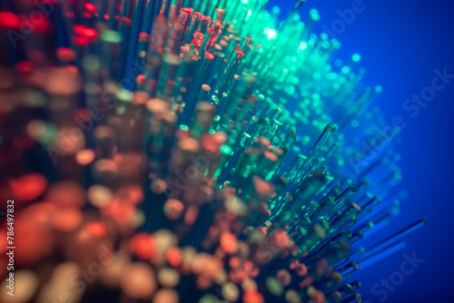 Conceptual multicolored image with short focal length fiber optic network cable for fast communication. Blue background, macro. photo