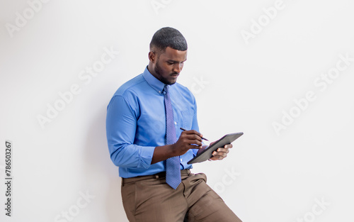 African handsome smart businessman wearing formal clothes, holding tablet with serious face, online meeting, standing in workplace, isolated white background cutout. Technology & Business Concept.