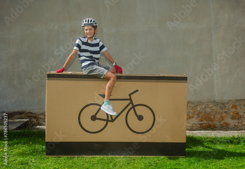 Grinning teenager cyclist posing on large bike-icon package