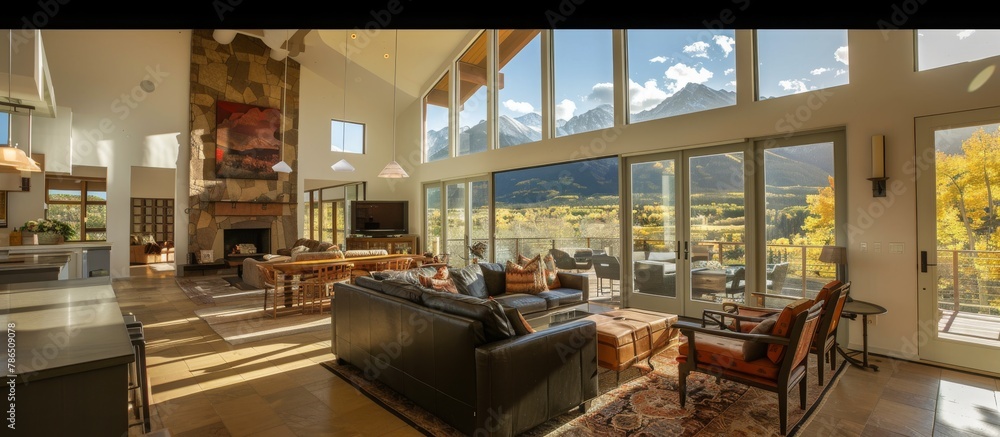 Fototapeta premium Spacious floor plan with high ceilings and large windows maximizes mountain scenery. 