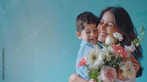 A woman is holding a child and a bouquet of flowers