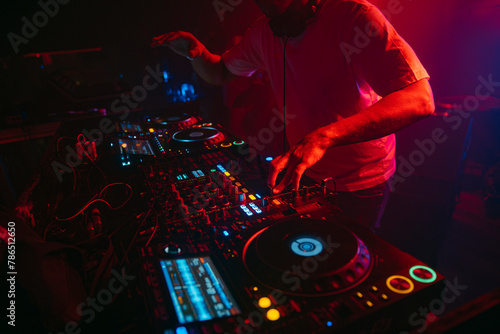 Close up view of a dj's hands playing the mixer while performing