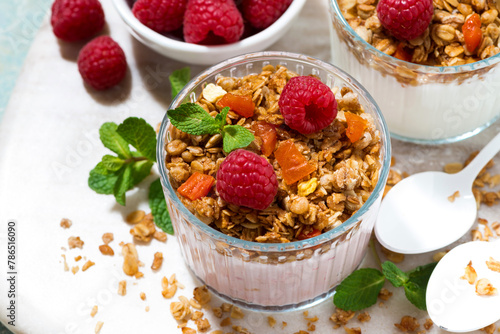 sweet dessert with granola, fresh raspberries and fruit  yoghurt, top view