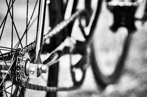 Close photo. Closeup of a chain and wheel on a fixed gear bicycle. Photo of chain and wheel.