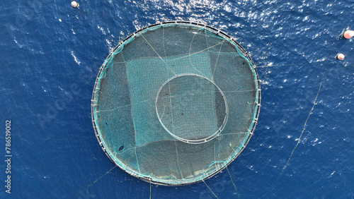 Aerial drone photo of latest technology self feeding fish farming unit of sea bream and sea bass in Mediterranean calm deep blue sea