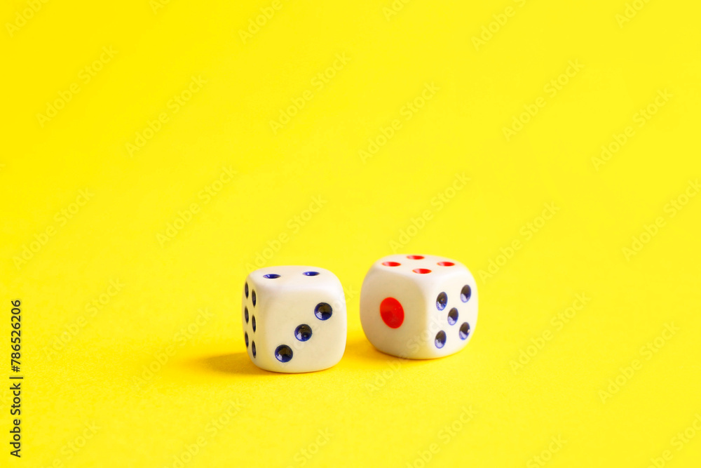 Two white game dices on yellow background Two white game dices on yellow background