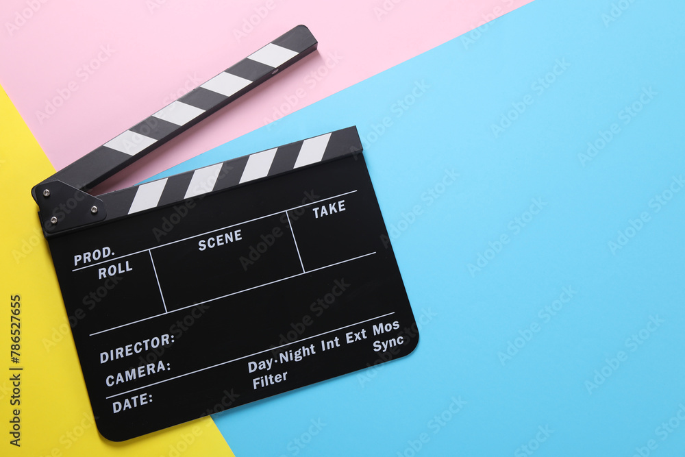 Naklejka premium Clapperboard on color background, top view. Space for text