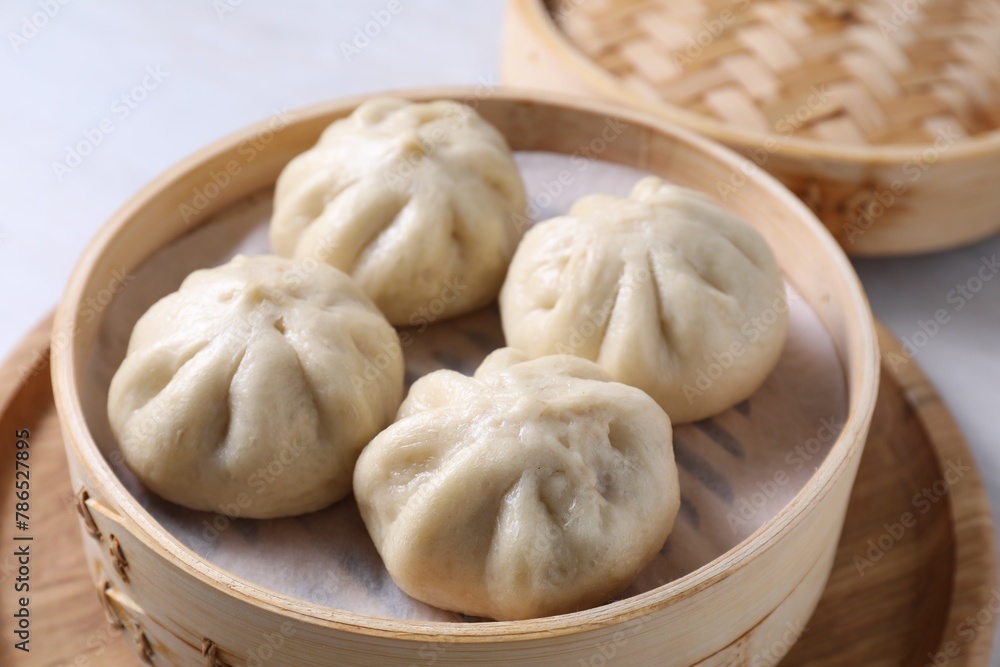 Obraz premium Delicious bao buns (baozi) on light table, closeup